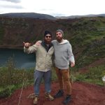 two men at a large crater lake