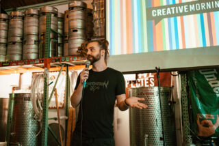 me talking in front of a creativemornings screen at speciation cellars