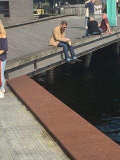 me drinking beer near jellyfish on a dock in copenhagen