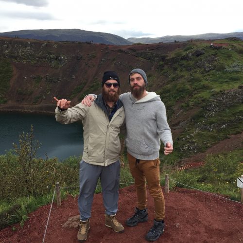 two men at a large crater lake