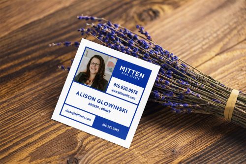 mitten real estate business card laying next to some lavender